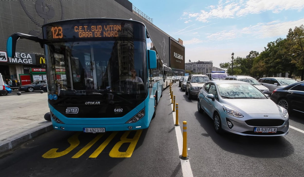 Bucharest, Romania - September 19, 2019: A public transport bus is driven on a bus lane in heavy traffic hours in Unirii Square in Bucharest, Romania.